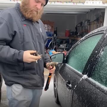 Using a hammer to open a frozen car door