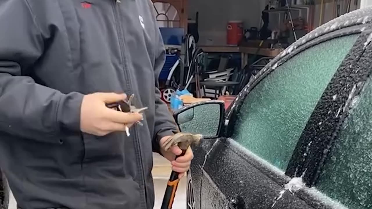 Using a hammer to open a frozen car door