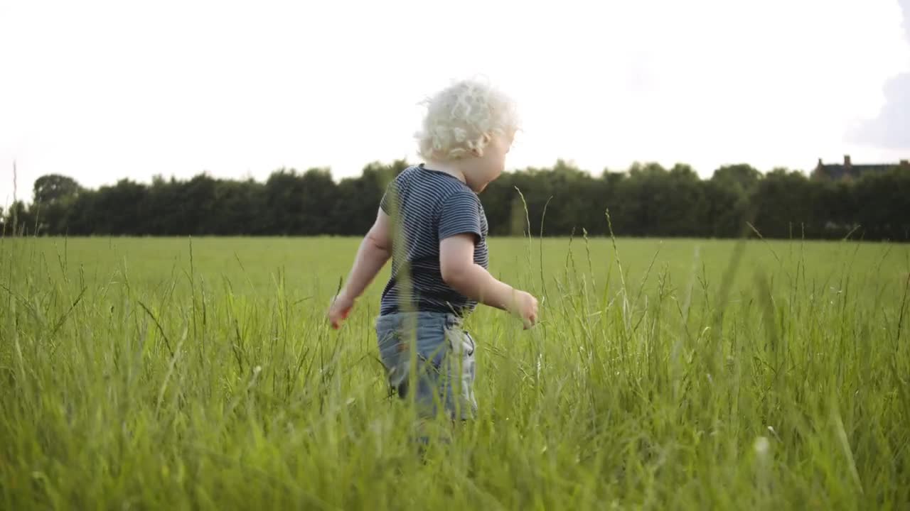 Toddler laughing outside