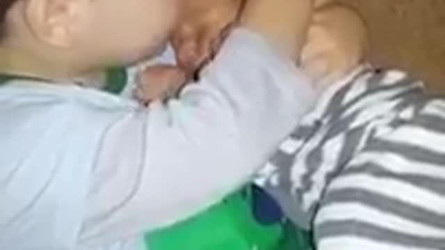 The baby gently hugs his newborn brother!