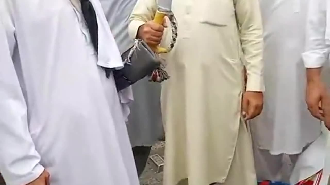 Muslim people in London bring up white weapons at a protest and flash them.