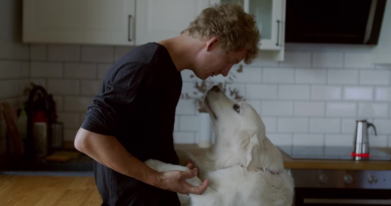 A Man Playing With His White Dog 2