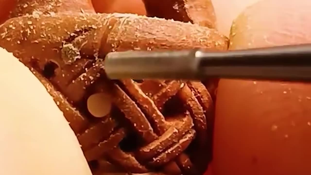 Artist turns fruit pit into a work of art!.hd