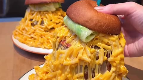 A superb hamburger filled with tons of macaroni and cheese!