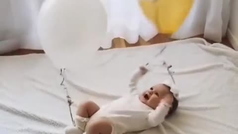 Baby playing with balloons, cuteness overload