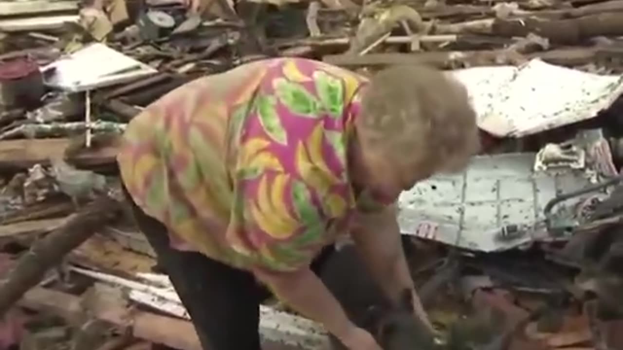 Tornado survivor finds her missing dog buried alive in rubble during a TV interview