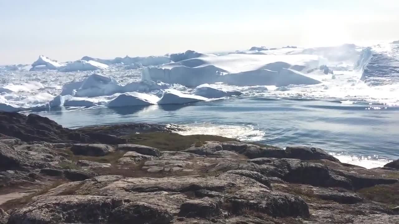 Ilulissat Icefjord - Large iceberg breaking over