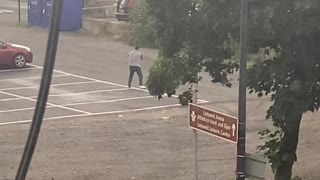 Man Punches Air in Parking Lot