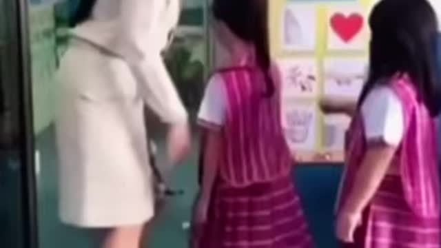 Teacher greets each kid with a dance move