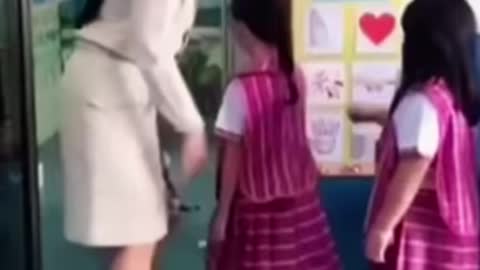 Teacher greets each kid with a dance move