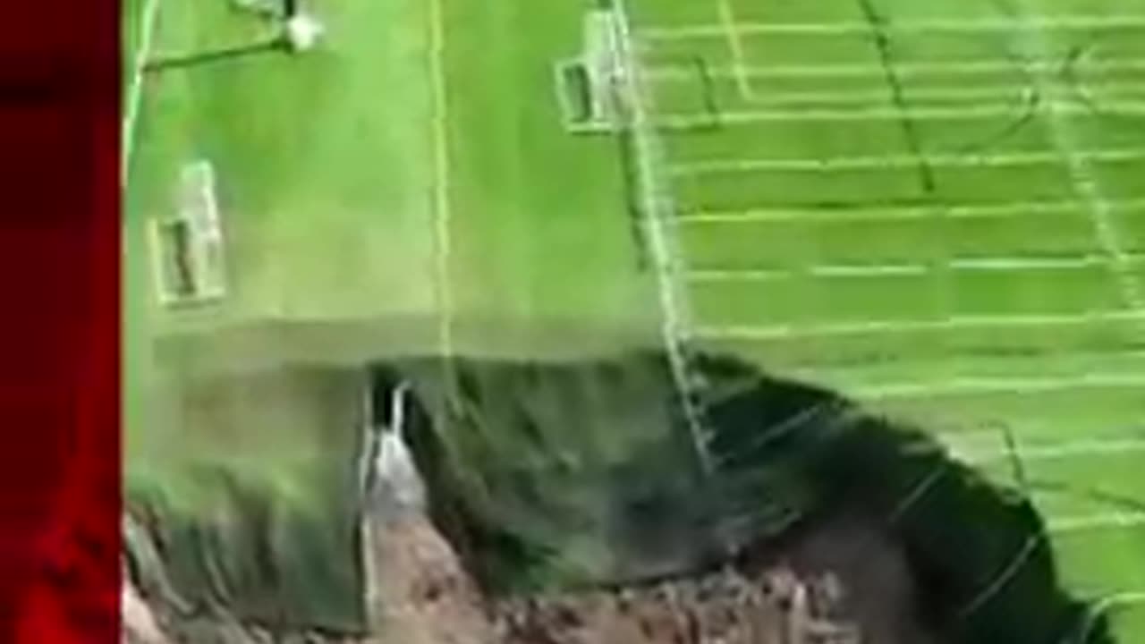 Watch moment sinkhole swallows football pitch leaving a 100 feet wide (30.5m) hole. _BBCNews)