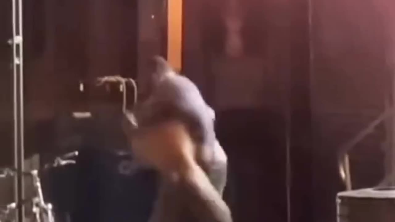 naked guy fighting another guy on the street.