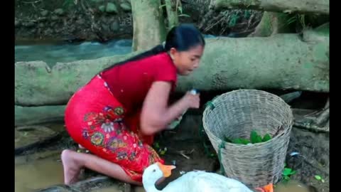 beautiful girl cooking a village-style crocodile