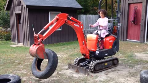 Jims Excavator #32 - 12-year-old Jamie stacking tires with the Kubota k008-3 excavator.