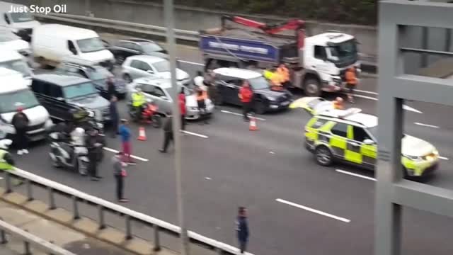 Just Stop Oil: Drivers get out of vehicles in standstill M25 traffic near Heathrow