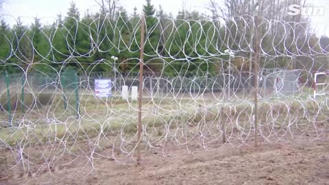 Polish soldiers build razor wire fence at border with Russia's Kaliningrad