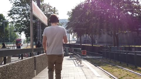 A Man walking on road with Headphones