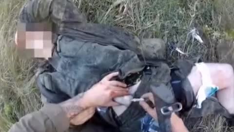 French NATO soldiers administer First Aid to a wounded Russian soldier
