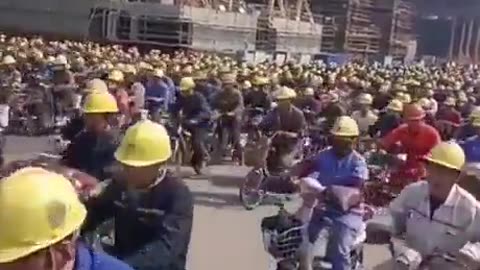 Workers from the Jiangsu shipbuilding plant ending their shift