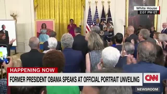 Barack Obama gives a speech after the unveiling of his White House portrait