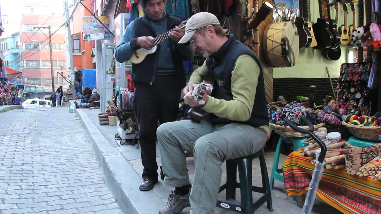 Tourist playing a guitar in a market