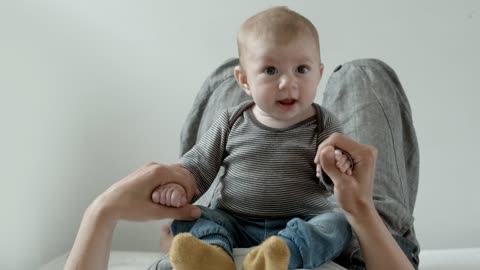 A cute baby playing with mother