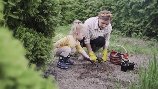 Baby girl helps Mother with agriculture