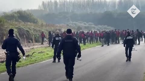 Migrants in life jackets throw rocks at French police to get to dinghies for Channel crossing