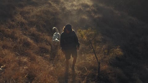 A man walking his dog in the morning