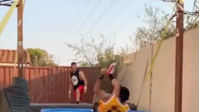 Guy Falls on Mattress While Hanging From Horizontal Bar and Performing Trick