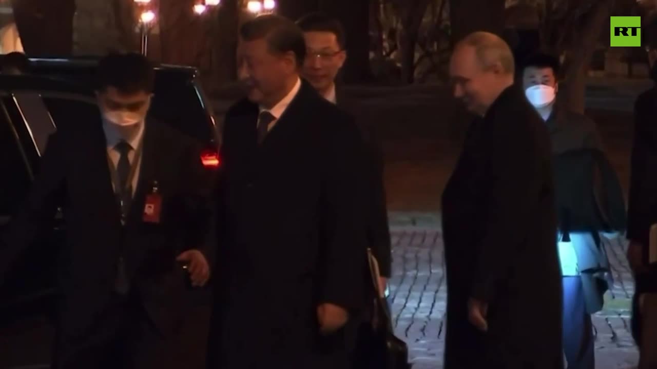 Putin escorts Xi to his car following the talks