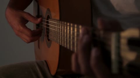 Person Playing A Guitar