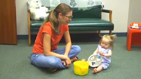 Cute baby girl playing with mom