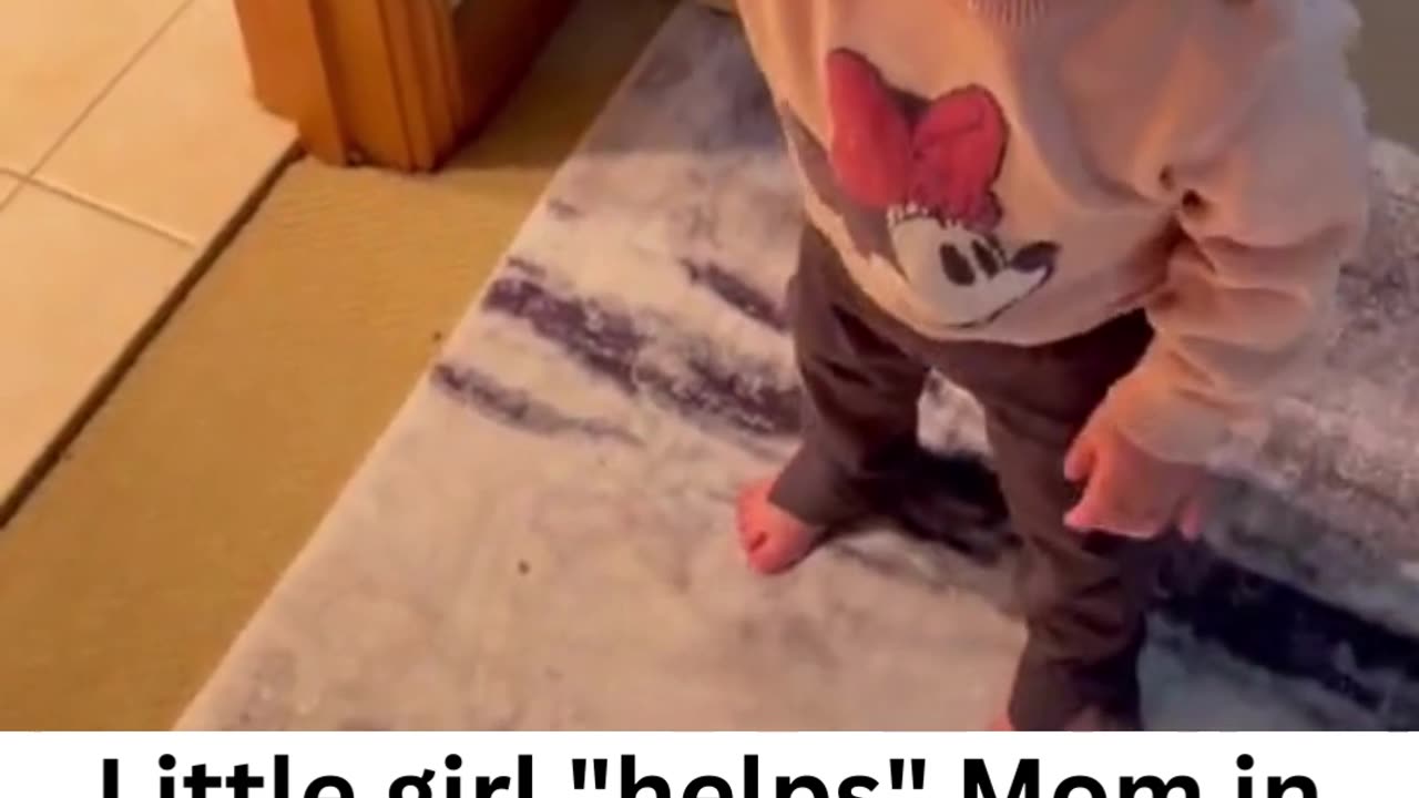 Toddler "helps" Mom in the bathroom.