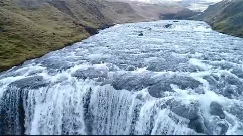 Unmanned flight over a waterfall