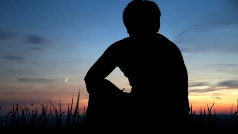 A sading Man in sunset and birds flying over him so emotional