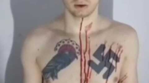 A captive Ukrainian neo-Nazi in all his tattooed glory