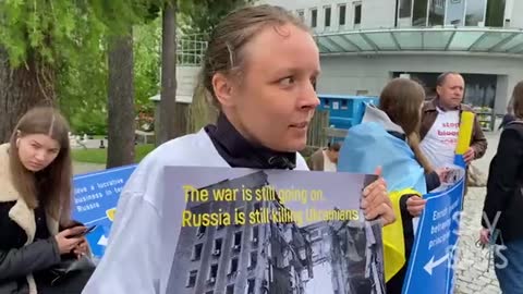 A Pro-Ukrainian activist in Davos almost starts crying as she tells reporter.. *See Description*
