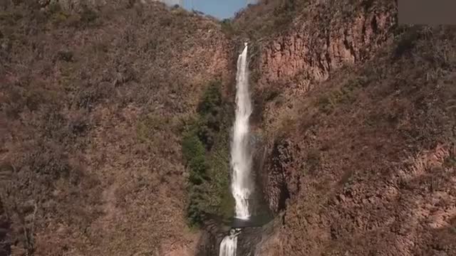 Aerial bird's eye view of cascade landscape scene shooting video