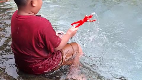 Alavaro playing in the fish pond