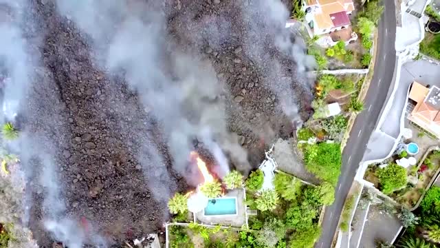 Drone shows lava swallowing La Palma swimming pool