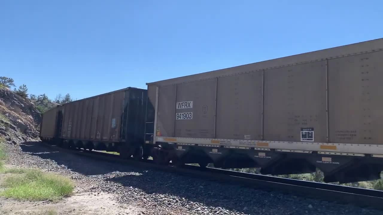 Solid EMD SD70ACe lineup up Mullan Pass. 3 BNSF, 4 MRL, then 1 BNSF on the rear.