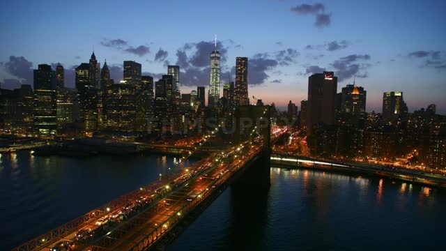 A well lit bridge leading to a city