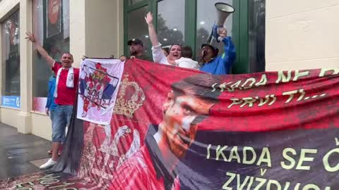 Melbourne Australia - Novak Djokovic. Supporters cheering & chanting for him in the rain outside the detention center