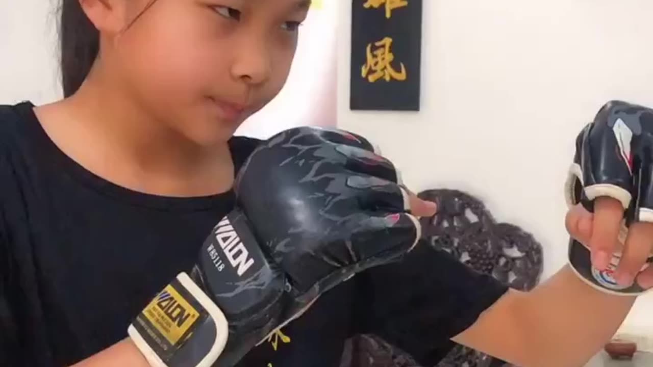 Girl training on a wooden dummy for Wing Chun Kung Fu