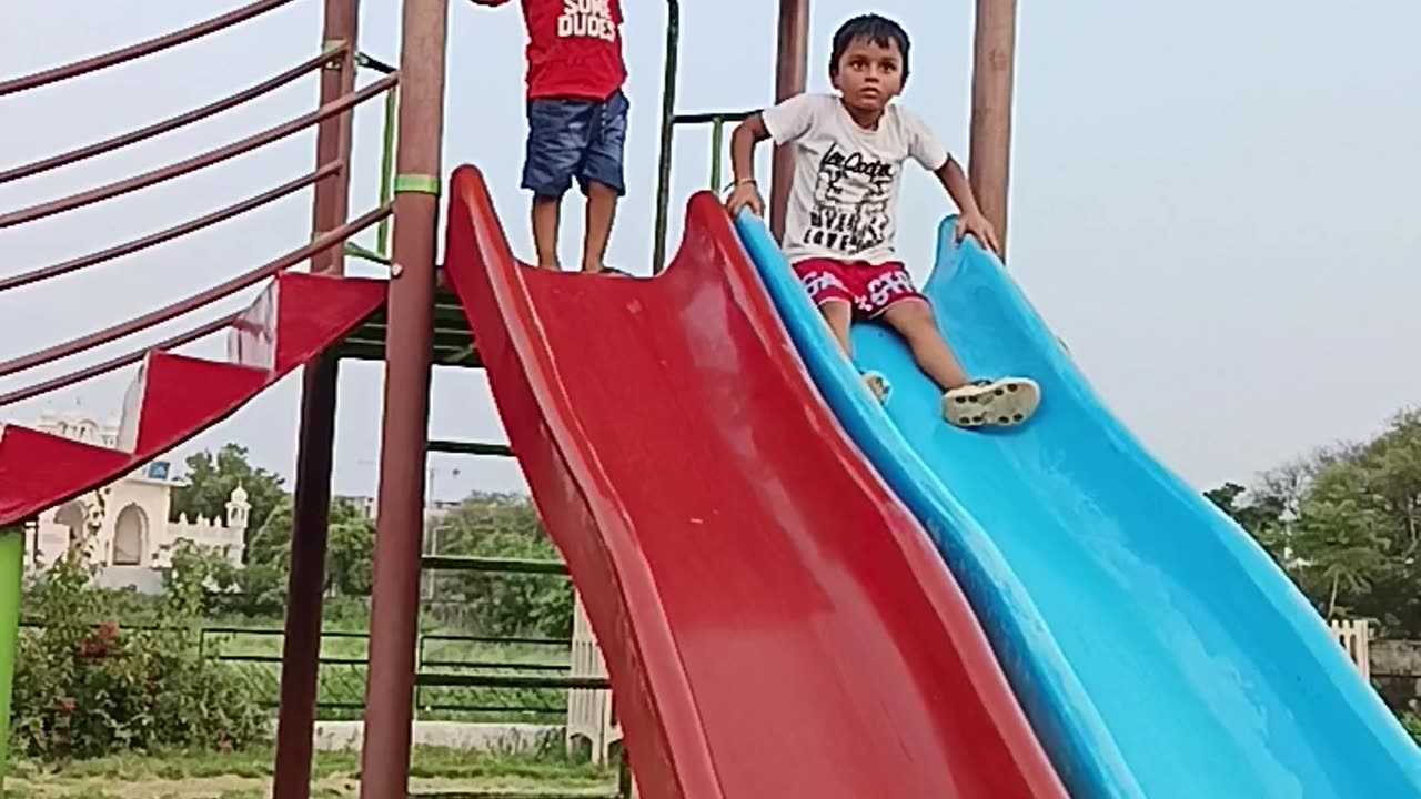 Indian park#small#children#playing#sliding