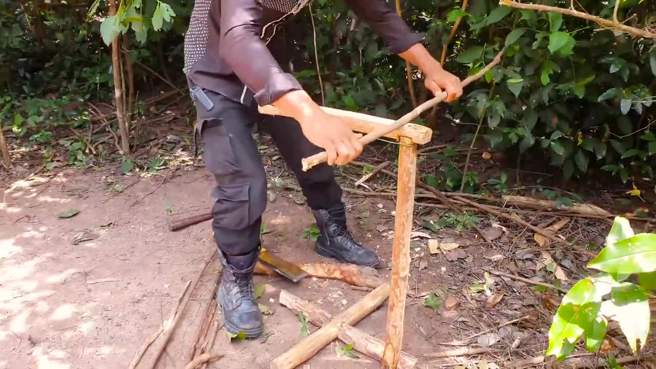 A busman constructs a wooden house in deep jungle