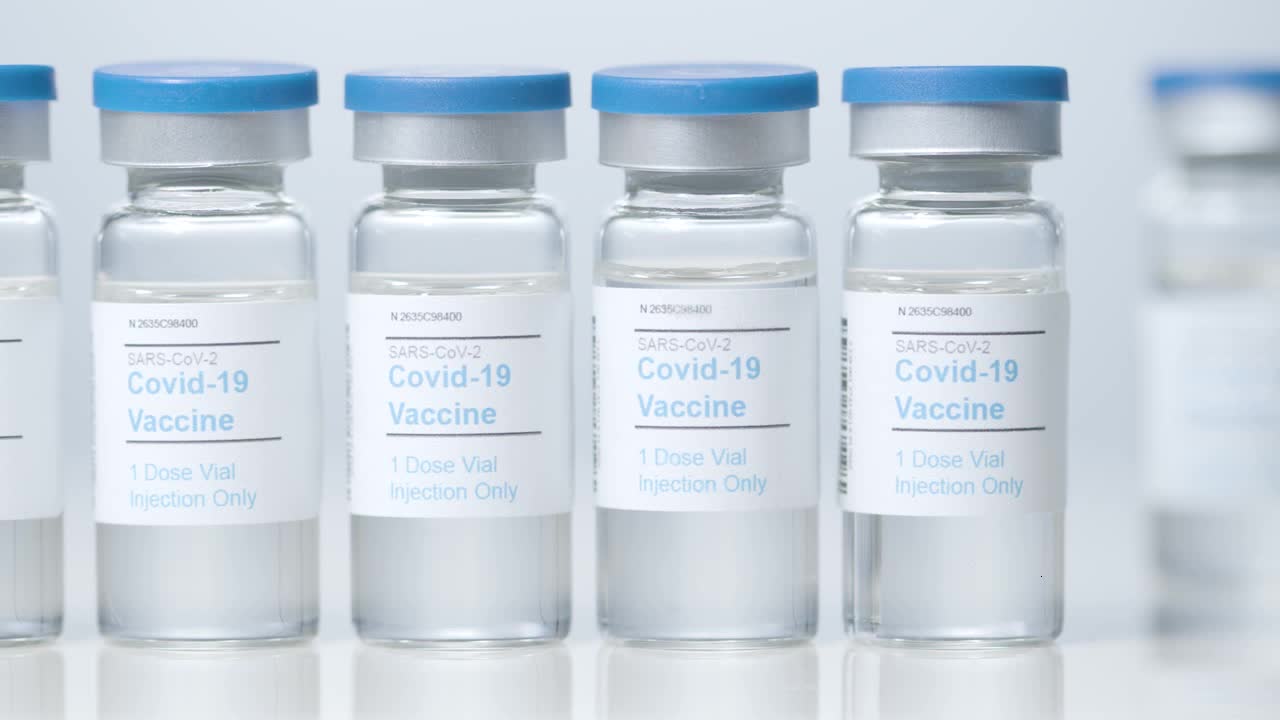 Sliding Close Up Shot of Four Vials Containing Covid 19 Vaccine