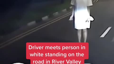 Driver meets person in white standing on the road in River Valley