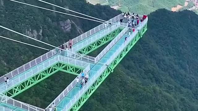 Hanging glass bridge over the abyss